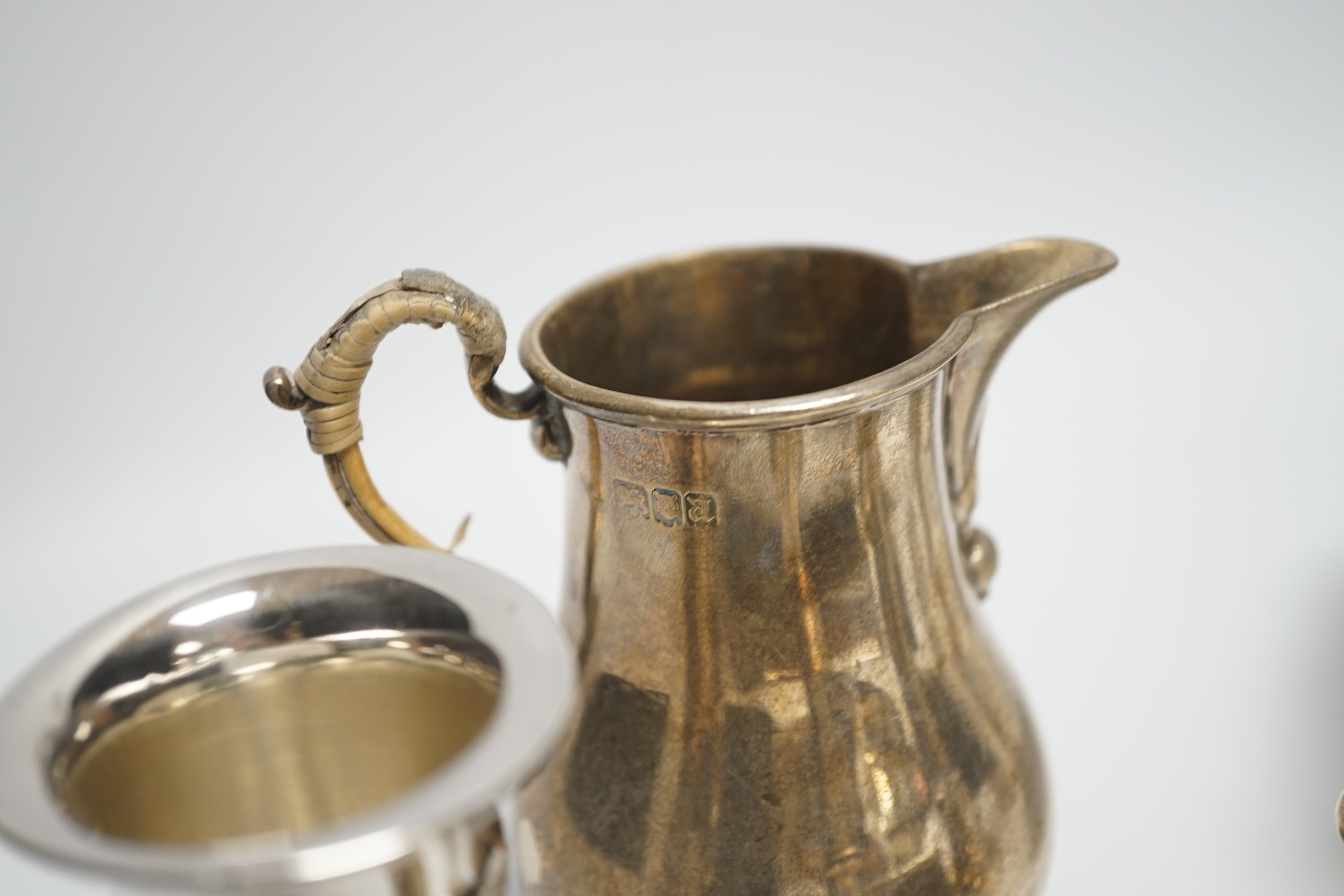 Sundry small silver including a silver sauceboat, George V sparrow beak cream jug, pair of pepperettes, napkin rings etc. and a letter opener/magnifying glass by Charles & George Asprey, London, 1908.